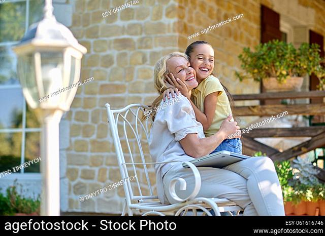 Happy moments. Mom hugging her daughter and looking happy
