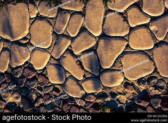Wall surface consisting of round rocks in the view