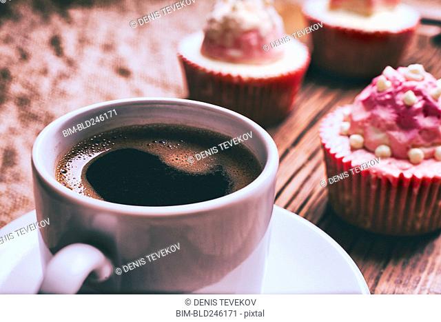 Close up of coffee and cupcakes