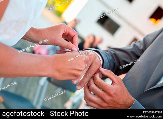 Bride and groom exchanging wedding rings. Stylish couple official ceremony. High quality photo