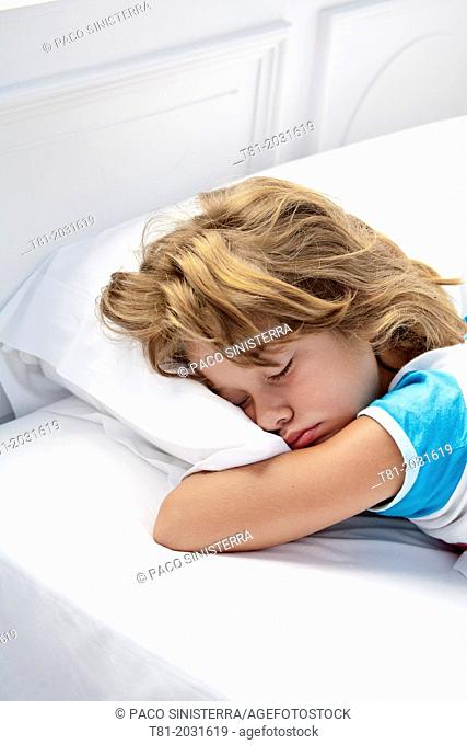 Sleeping girl, white sheets, face down, Ribadesella, Spain
