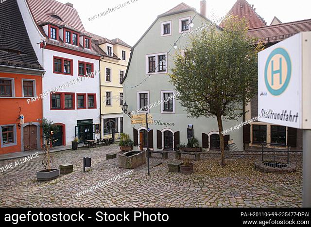 06 November 2020, Saxony, Meißen: View of the deserted square at Cafe Ziger in the old town. The federal and state governments have decided on a partial...