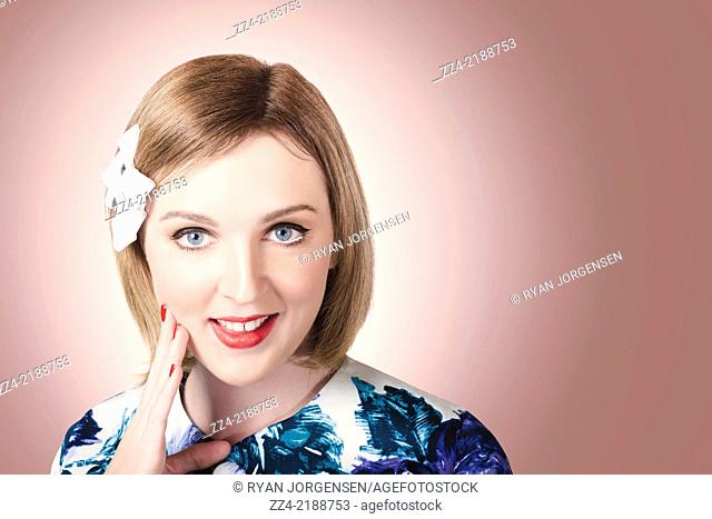 Old fashioned portrait on the face of a thinking pin up lady with smile wearing cute hair bows in short bob hairstyle. Copyspace hairdressing concept