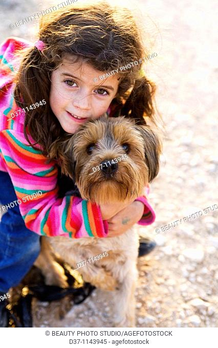 Little girl with a Yorkshire Terrier dog