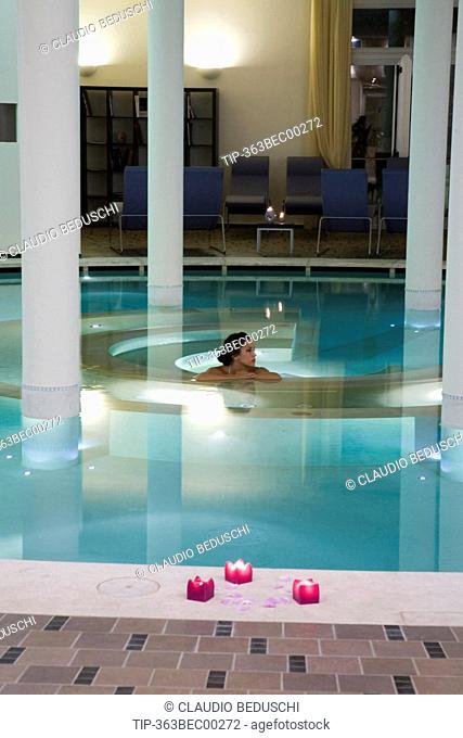 Woman at spa relaxing in pool