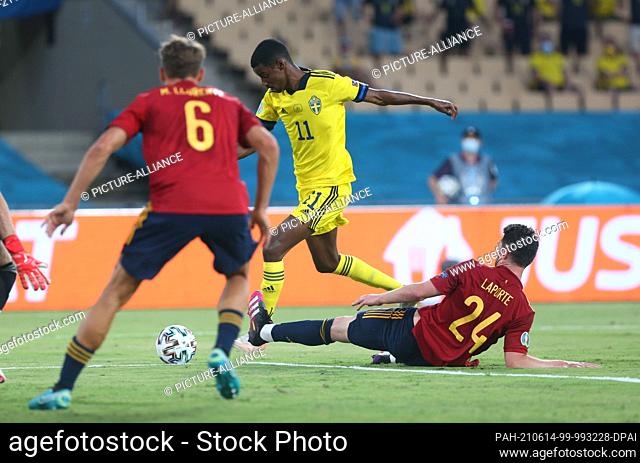 14 June 2021, Spain, Sevilla: Football: European Championship Group E, Spain - Sweden: Sweden's Alexander Isak passes the ball between Spain's Marcos Llorente...
