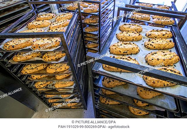 18 October 2019, Saxony, Dresden: Freshly baked Christmas stollen lie on transport trolleys in the Dresden baking house at the open window and cool down