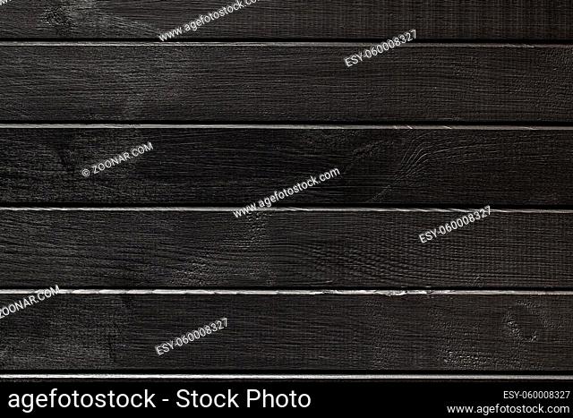 Black plank background. Blank wooden background. Black wooden wall. Top view