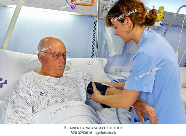 Nurse taking a patient's blood pressure, hospital room, Hospital Donostia, San Sebastian, Gipuzkoa, Basque Country, Spain