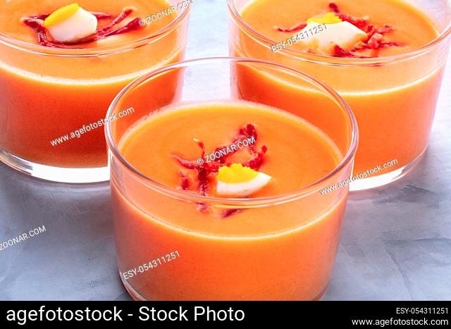 Salmorejo, Spanish cold tomato and bread soup, served in glasses, close-up shot