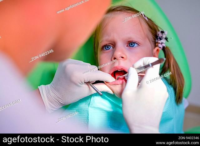 Healthy teeth patient girl in dentist office - dental caries prevention