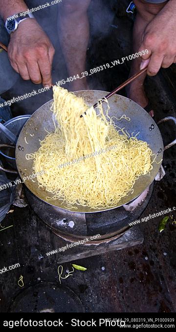 Cook prepares Vietnamese noodles popular island party cruise Number 4 Nha Trang beach resort Vietnam