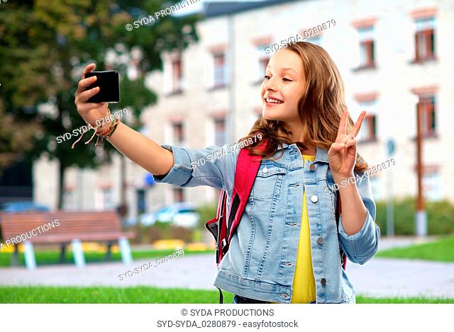 teenage student girl taking selfie by smartphone