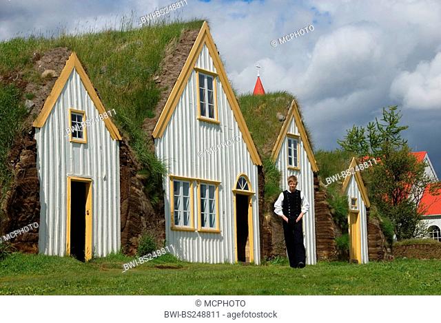 Junge in traditional dress peat houses in with grass roofs in open-air museums Glaumbaer, Iceland