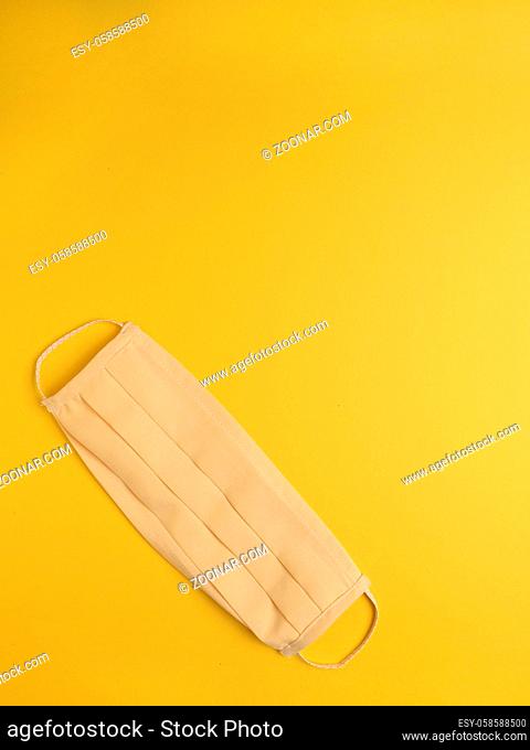 Close up of a homemade mouth guard on a yellow background, protection or safety concept