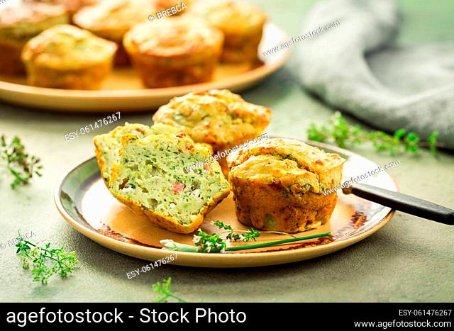 Homemade savory zucchini muffins with herbs, feta cheese and bacon