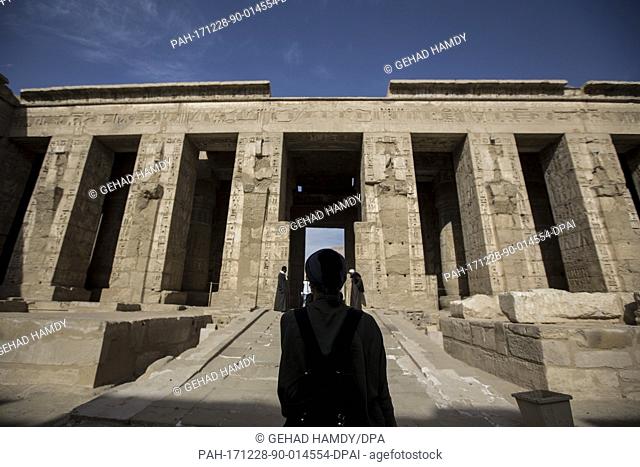 A picture provided on 28 December 2017 shows a tourist visiting the Mortuary Temple of Ramesses III at Medinet Habu , in Luxor, Upper Egypt, 10 December 2017
