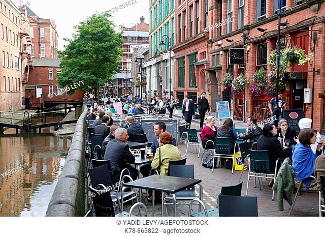 People sitting at outdoors cafes on Canal street known also as the Gay village, Manchester, England, UK