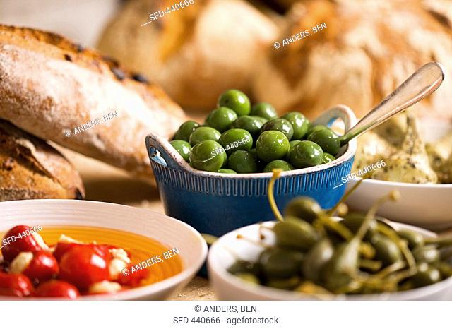 Still life with green olives in small bowl
