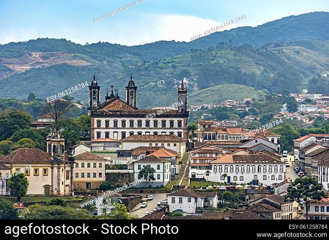 View of the historic city of Ouro Preto in Minas Gerais with its colonial-style houses and churches and the mountains in the background