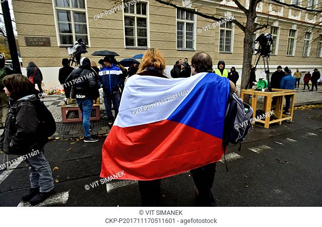 A couple of people with Czech flag on their shoulders are seen in Albertov Street in Prague, near the memorial plaque which reminded to the 1989 events that...