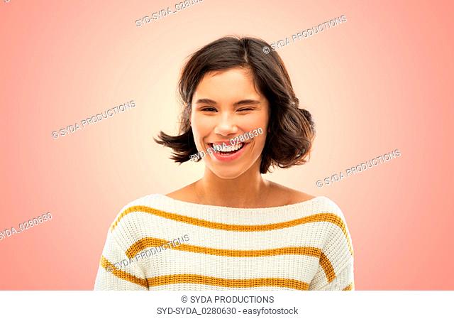 happy smiling woman in striped pullover winking