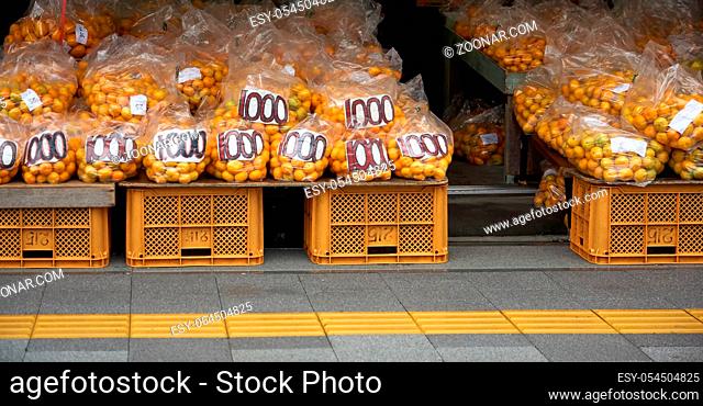 A counter with tangerines (Japanese mikans) along the road of Kii Peninsula in the fall. Wakayama. Japan