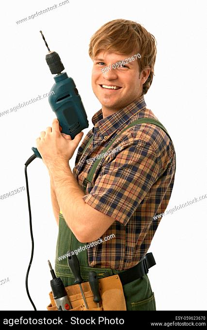 Happy handyman posing with power drill, smiling. Isolated on white