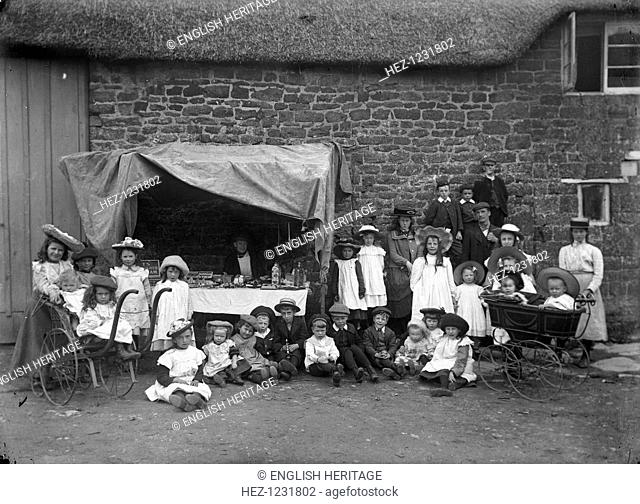 Bric-a-brac stall, Helidon, Northamptonshire, c1896-c1920. Children grouped around a bric-a-brac stall at Hellidon, Northamptonshire