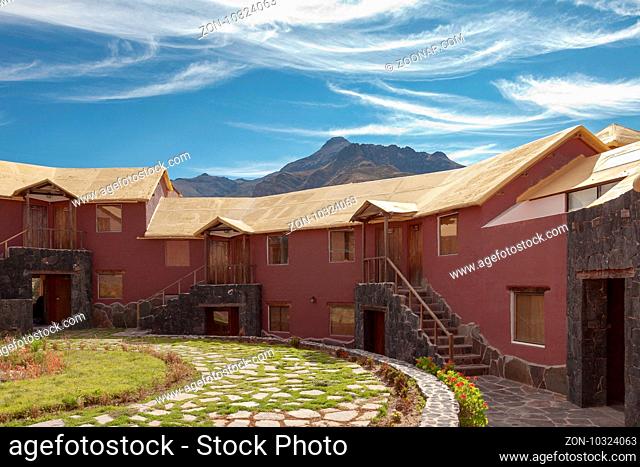 A traditional vintage hotel in Chivay, Arequipa Peru with mountains and blue sky