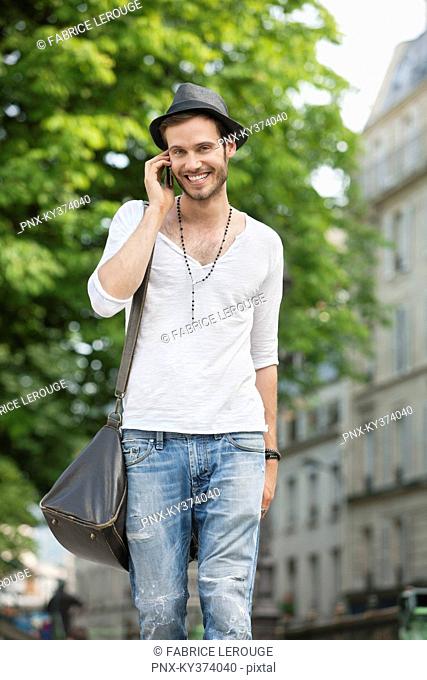Portrait of a man talking on a mobile phone, Paris, Ile-de-France, France
