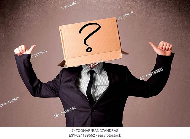 Businessman gesturing with a cardboard box on his head with question mark