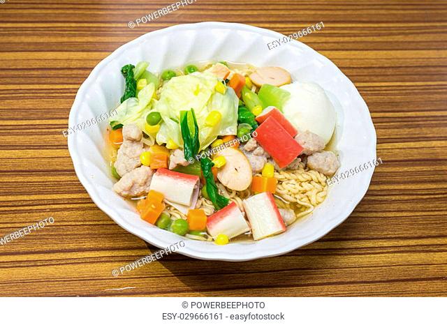 Noodles with vegetables and meat to eat healthy on wood table, Thai food