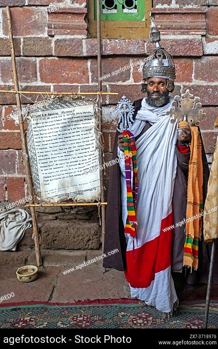 Portrait of an ethiopian orthodox priest holding a cross in nakuto lab cave church, Amhara region, Lalibela, Ethiopia