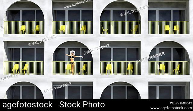 Woman wearing bikini standing in balcony of hotel during vacation