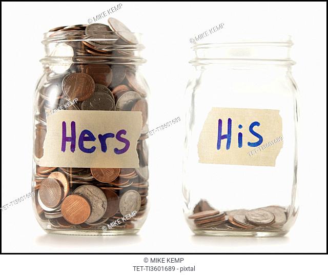 Studio shot of two jars with coins labeled Hers and His