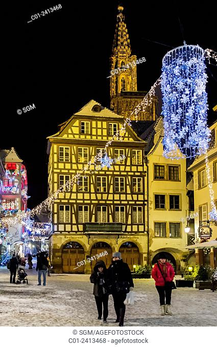 Snowy 'Place du Marché aux Cochons de Lait' square and cathedral at night on Christmas time Strasbourg Alsace France