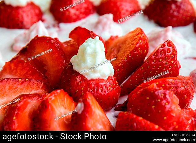 closeup of homemade fresh strawberry cake with whipped cream