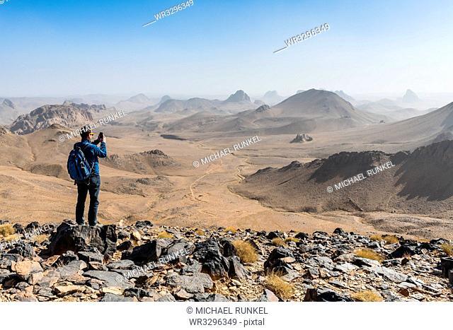 Man enjoying the mounains of Assekrem, Tamanrasset, Hoggar mountains, Algeria, North Africa, Africa
