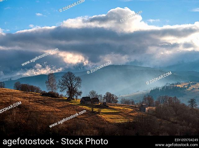 Picturesque morning above late autumn mountain countryside. Ukraine, Carpathian Mountains. Peaceful traveling, seasonal, nature and countryside beauty concept...