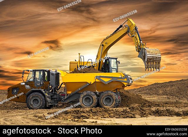 excavator working on construction site with dramatic clouds on sky