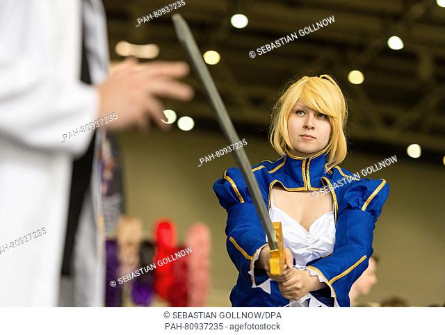 A woman dressed as Saber, also known as Arturia Pendragon, from the series Fate/stay night poses at the MGM Comic Con in Hanover,  Germany, 04 June 2016