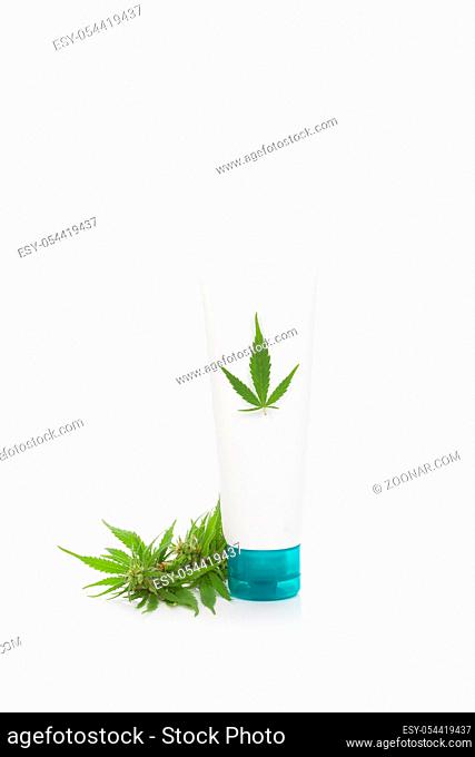 Marijuana cream tube with cannabis plant, isolated on white background. Medical marijuana, natural cosmetics