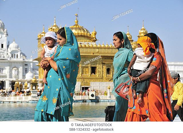 Pilgrims walking around Golden Temple by the holly lake, Punjab Amritsar India