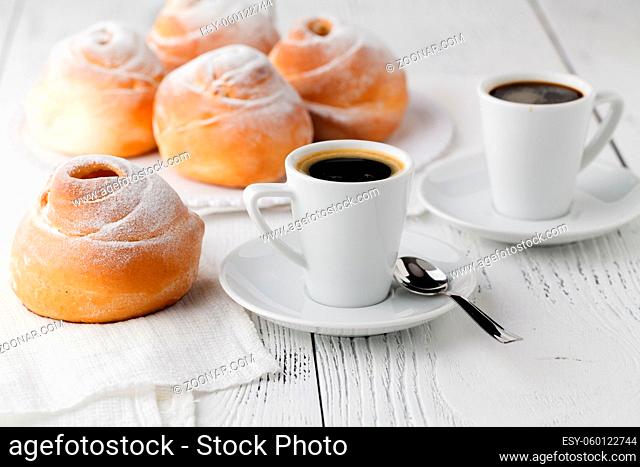 a dish of choux cream with a cup of tea or coffee for an afternoon break