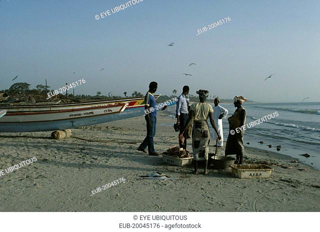 People buying freshly caught fish on the beach