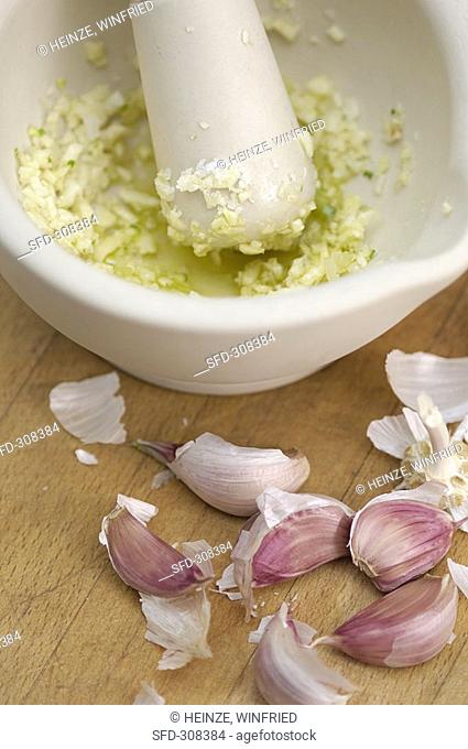 Crushing garlic in mortar