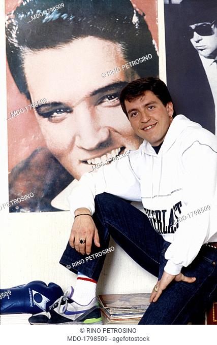 Ricky Memphis, recently appeared at the Maurizio Costanzo Show, poses into his room before a poster of Elvis and another one of the Blues Brothers; the young...