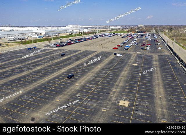 Detroit, Michigan USA - 18 April 2020 - The nearly empty parking lot where trucks and cars built by Fiat Chrysler normally await transport to dealers