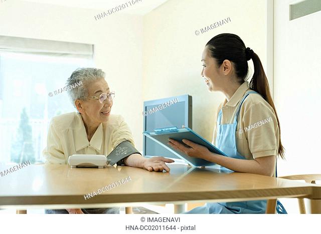Senior woman checking blood pressure